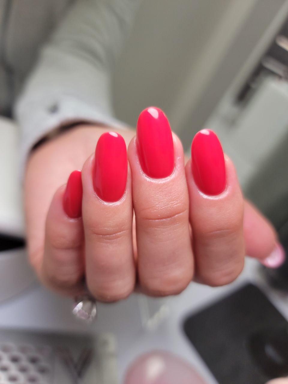Nail art using Vibrant Red-Orange Base Gel paired with gold accents and a glossy topcoat.