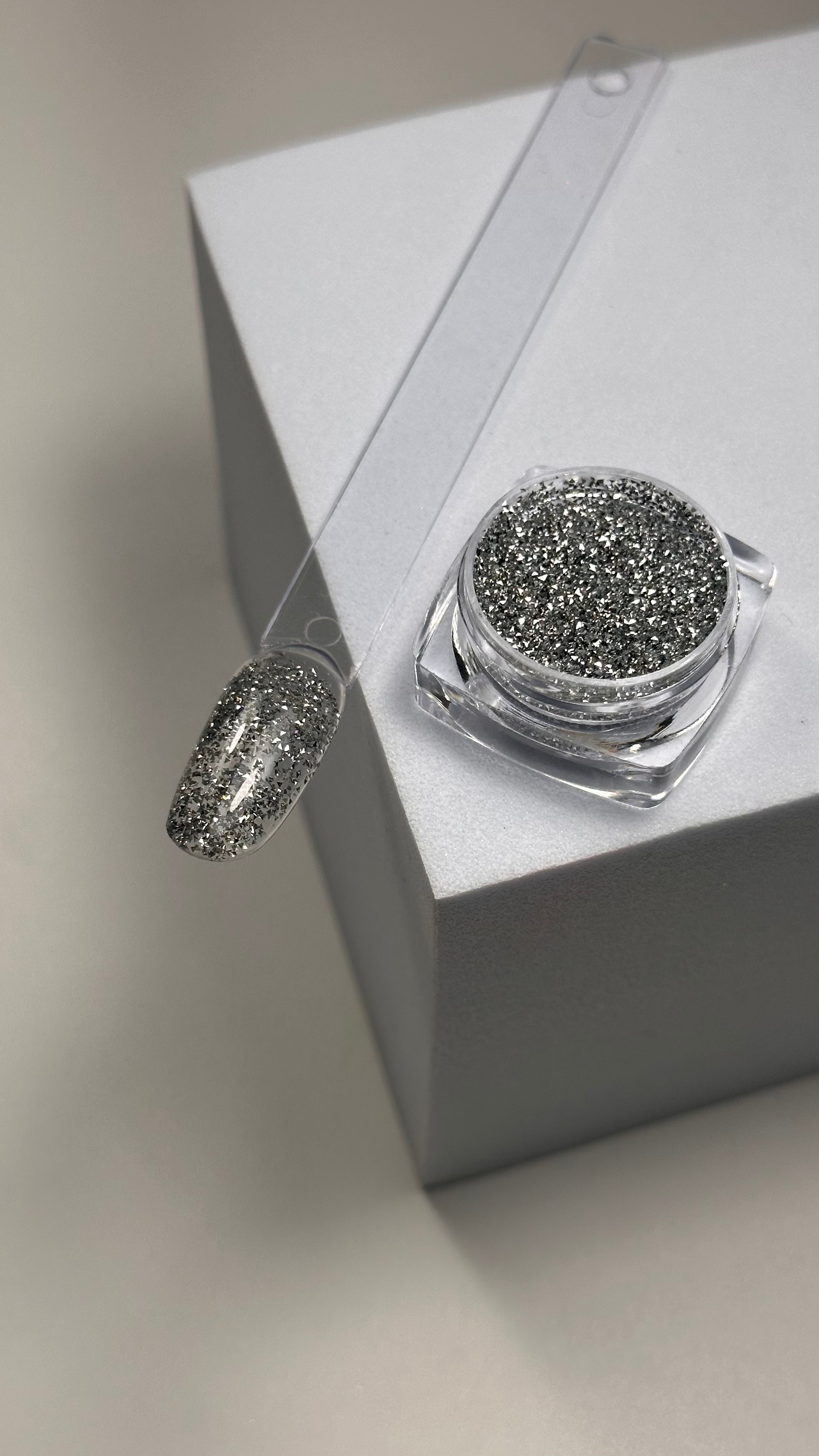 Get a show-stopping crystal nail look with our unique silver triangle nail art embellishments! These tiny silver nail triangles can be effortlessly mixed with gel or stuck on polygel, adding a stunning crystal nail effect that sparkles from every angle. Perfect for creating luxury nail designs at home or in the salon, these silver nail decorations bring an eye-catching shine and glamour to any nail art look. Whether you’re a pro or a DIY enthusiast, our silver triangles help you achieve a crystal-inspired m