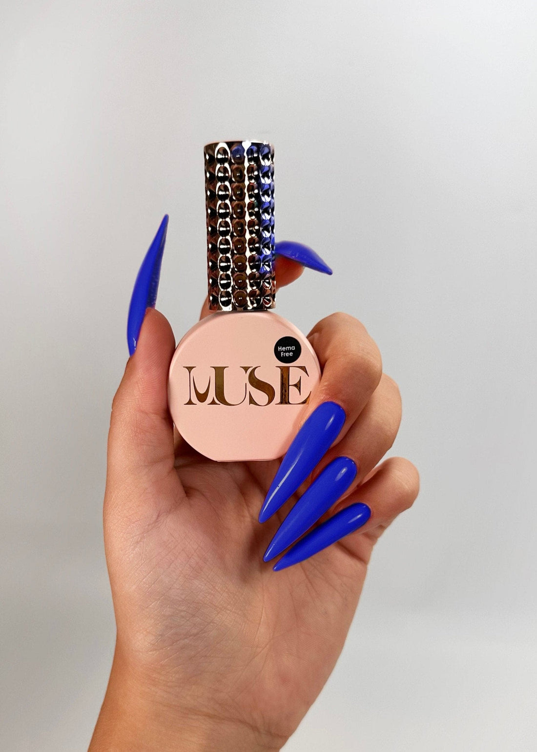 A set of nails painted in a deep, rich Classic Blue with Muse Gel’s Gel Polish, showcasing a glossy and smooth finish perfect for salon and home use.