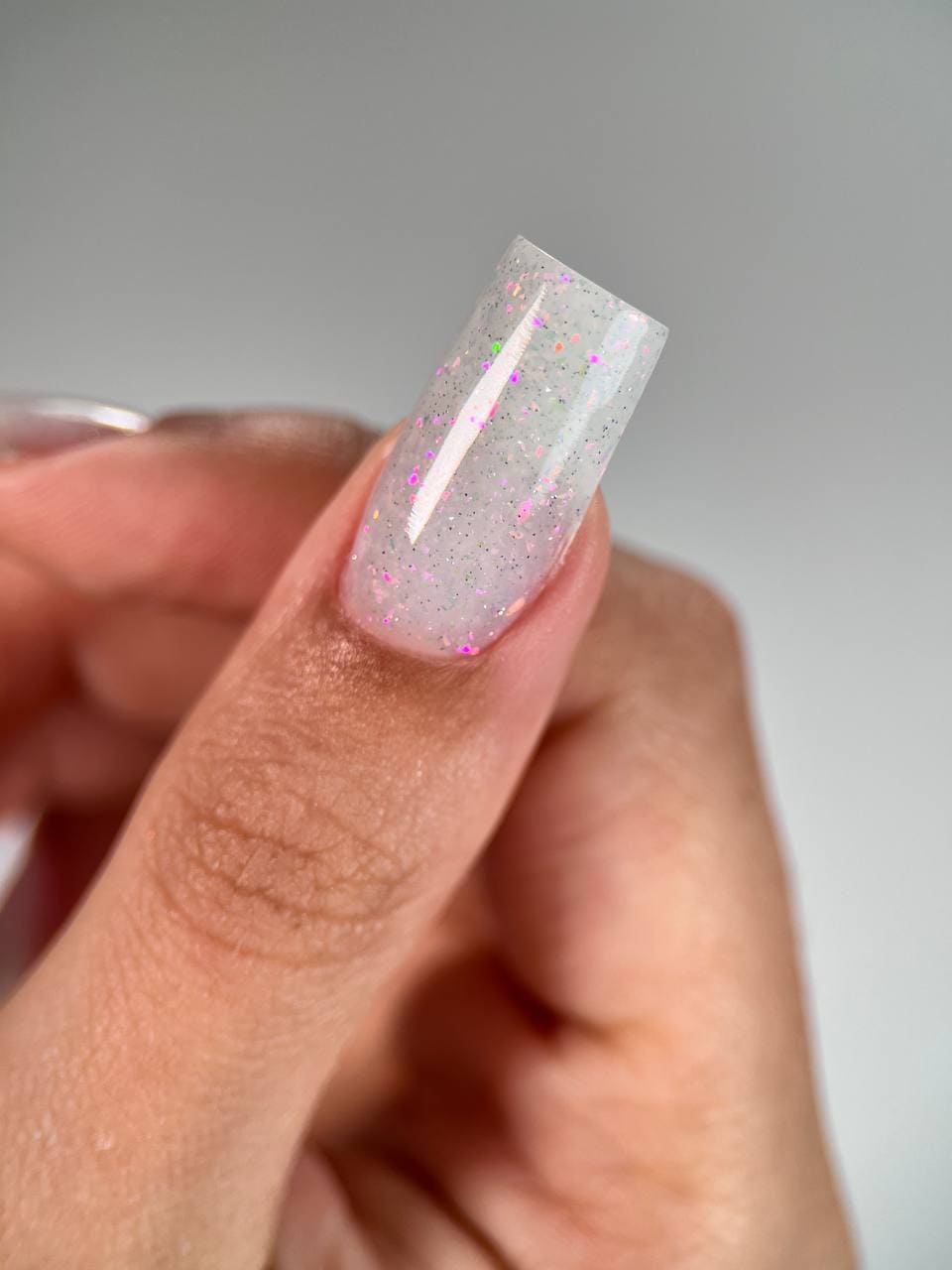 Close-up of Liquid PolyGel #1 bottle with Milky and White Holographic Sparkles.