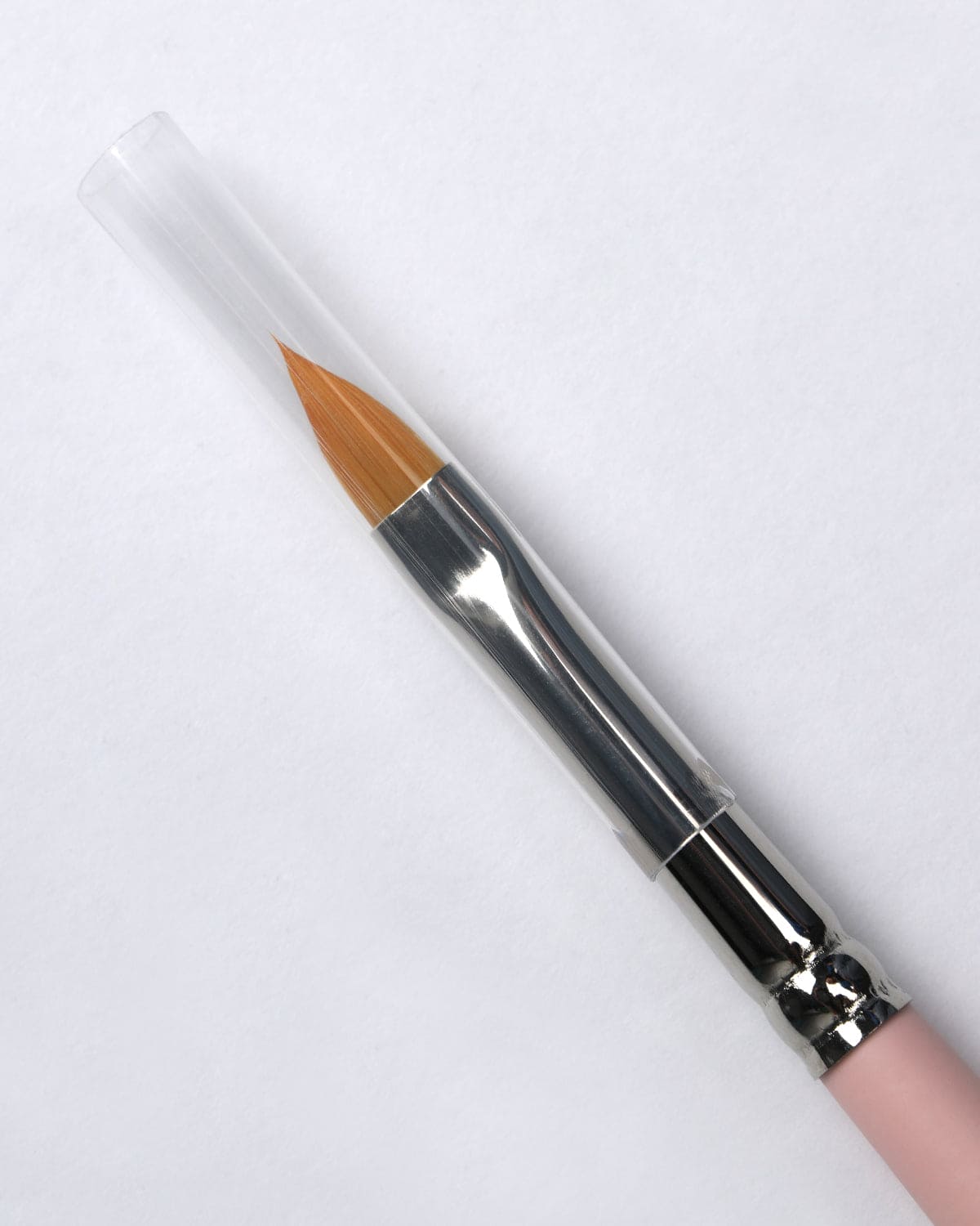 Makeup pencil with a white cap on a light gray background