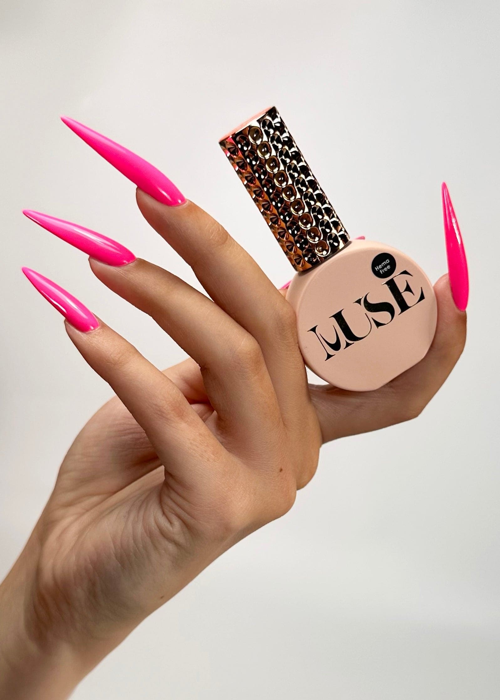 Nails painted with Muse Gel’s Neon Pink Gel Polish, showcasing vibrant neon pink full coverage and playful geometric designs, perfect for professional nail art in salons and at-home applications.