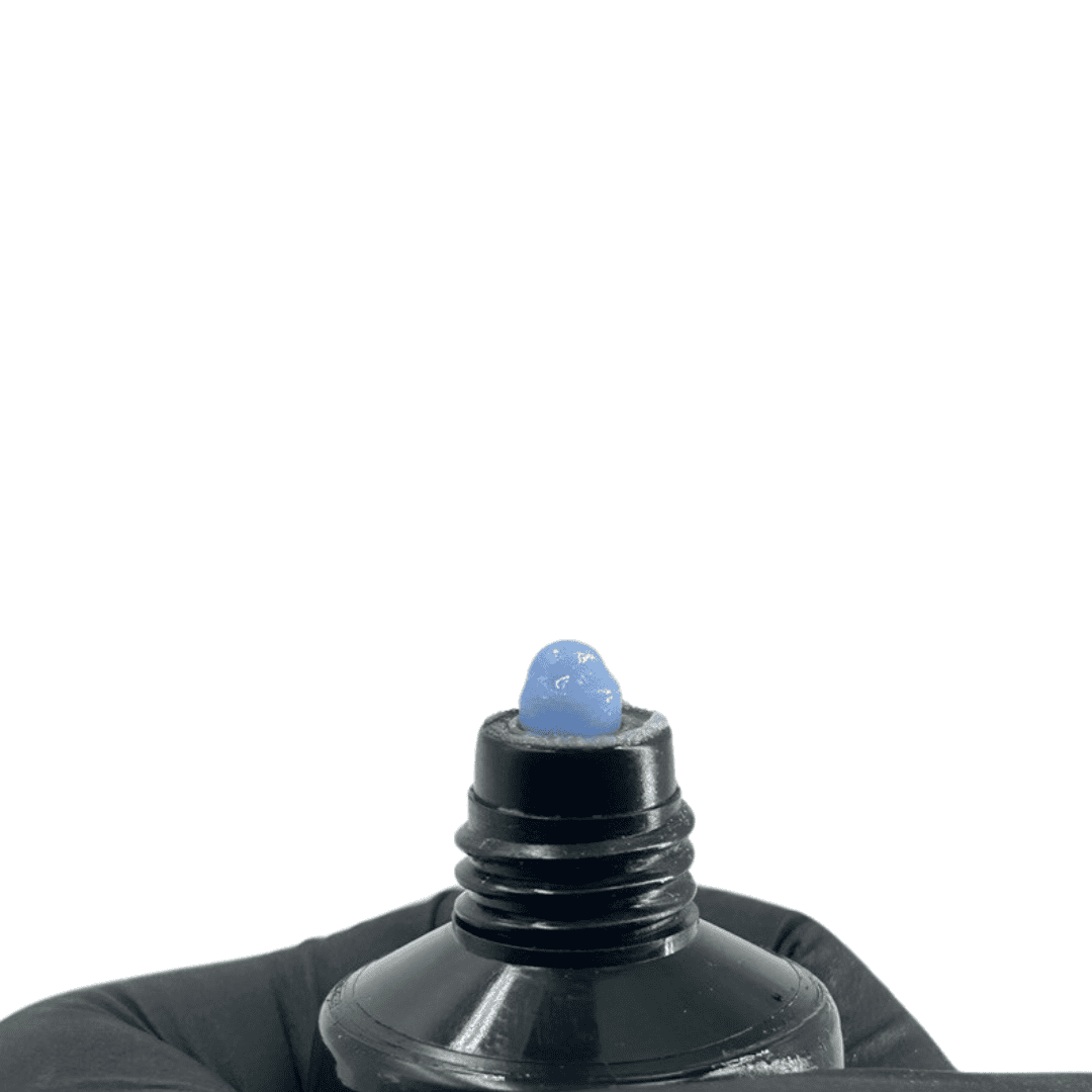 "Close-up of an open black squeeze tube of Muse Polygel, showing a blob of blue polygel on the tube's nozzle."