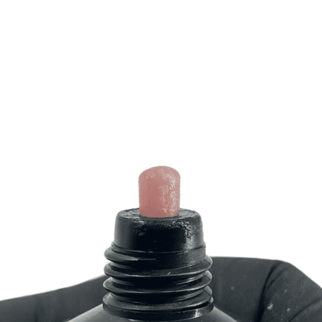 A black tube with a touch of mauve-colored polygel at the tip, showcasing the gel's consistency and shade for nail enhancements.