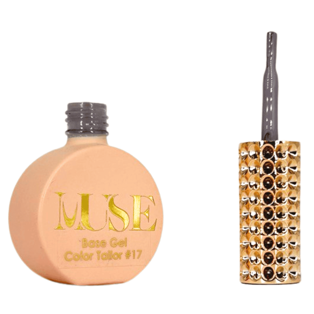 "A bottle of MUSE Base Gel in a nude shade labeled Color Tailor #17 with the cap off, alongside a brush with a brown handle and a gold-studded brush head."