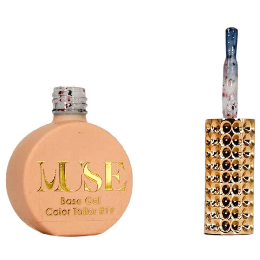 "A bottle of MUSE Base Gel in a light peach shade labeled Color Tailor #19 with the cap off, showing a brush with a multicolored handle speckled with red and black dots and a gold-studded brush head."