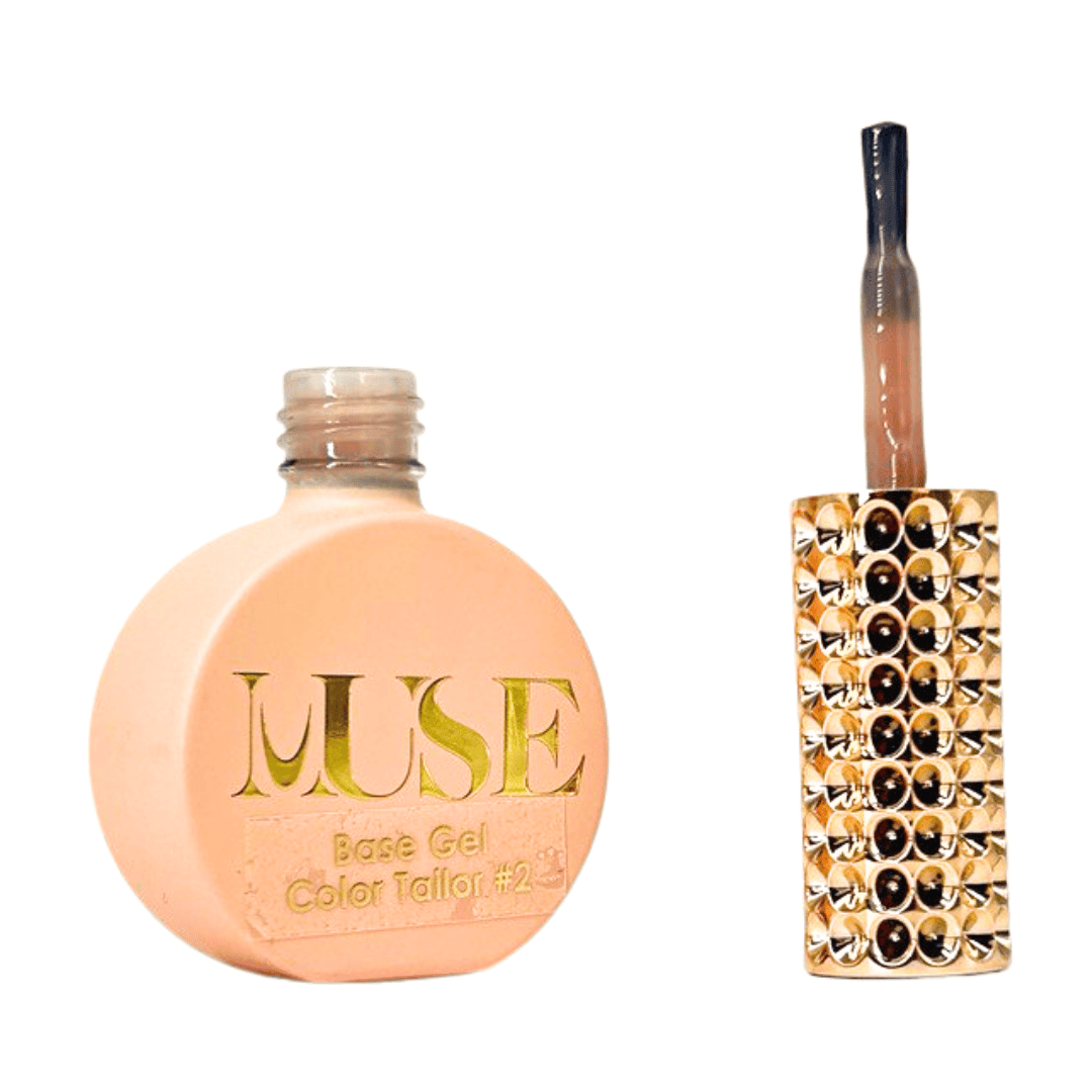 This image displays a nail polish or gel bottle on the left with the label "MUSE Base Gel Color Tailor #2," indicating it's a slightly different shade than the previous product. On the right is a brush applicator with an ornate handle studded with a double row of gold and black gems, consistent with a luxurious beauty product.