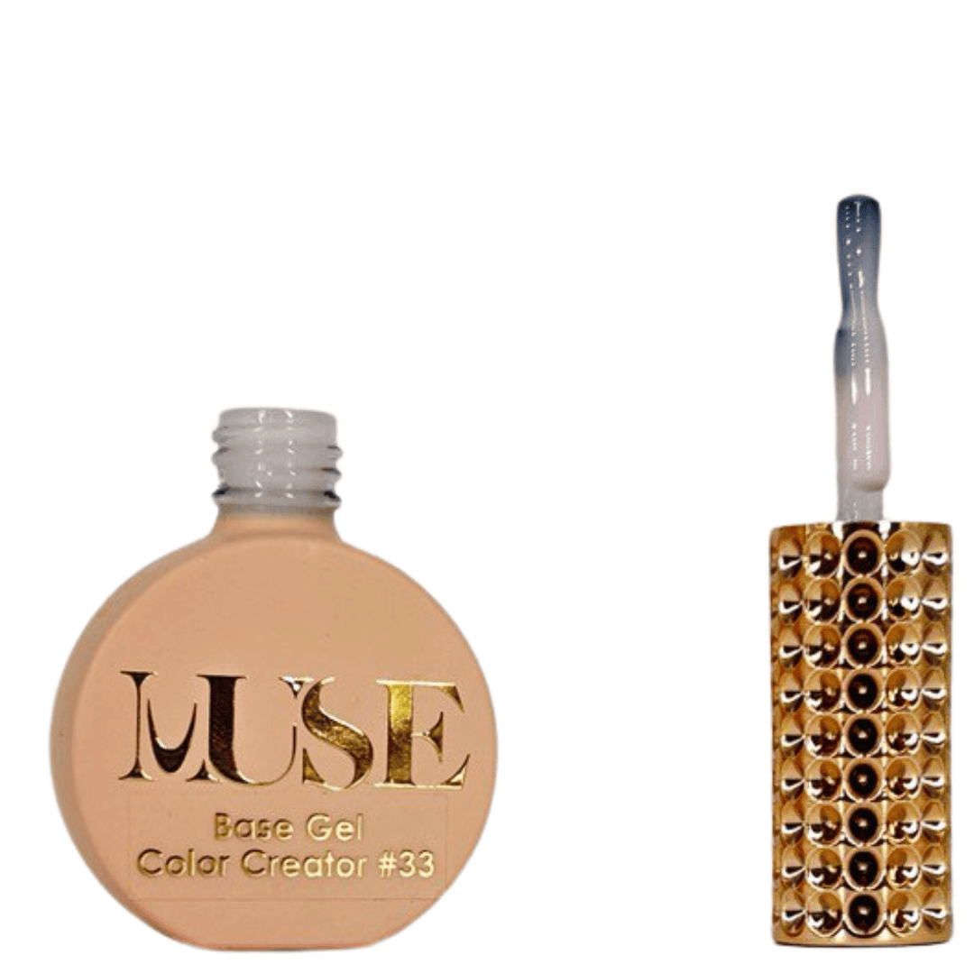 "A pale peach-colored bottle labeled 'MUSE Base Gel Color Creator #33' with a matching brush handle adorned with crystals."