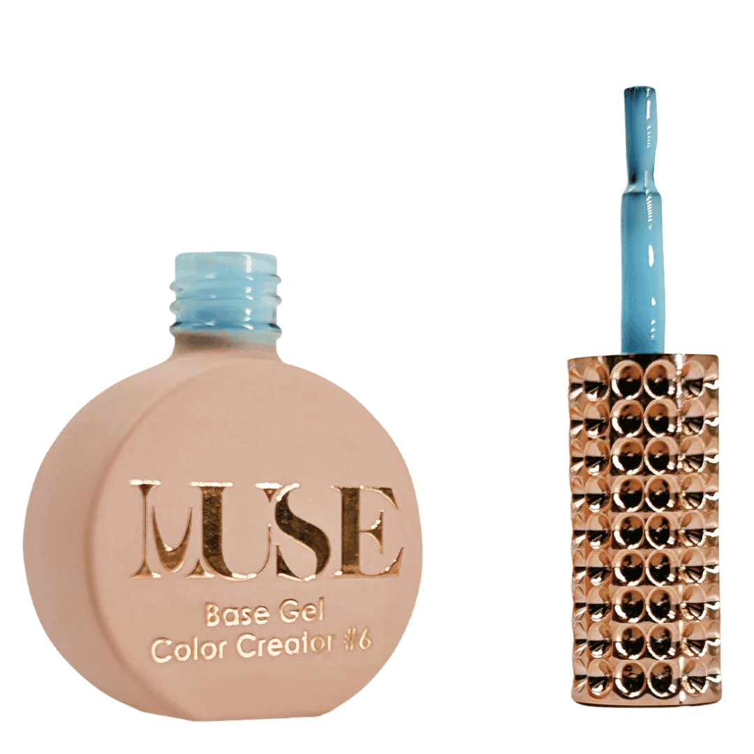 A bottle of MUSE Base Gel nail polish in a flat, round shape with a matte peach finish. The cap is a glossy light blue color, and the brush applicator is attached, adorned with multiple shiny rhinestones. The label on the bottle features the brand name "MUSE" in gold lettering with the text "Base Gel Color Creator #6" beneath it.