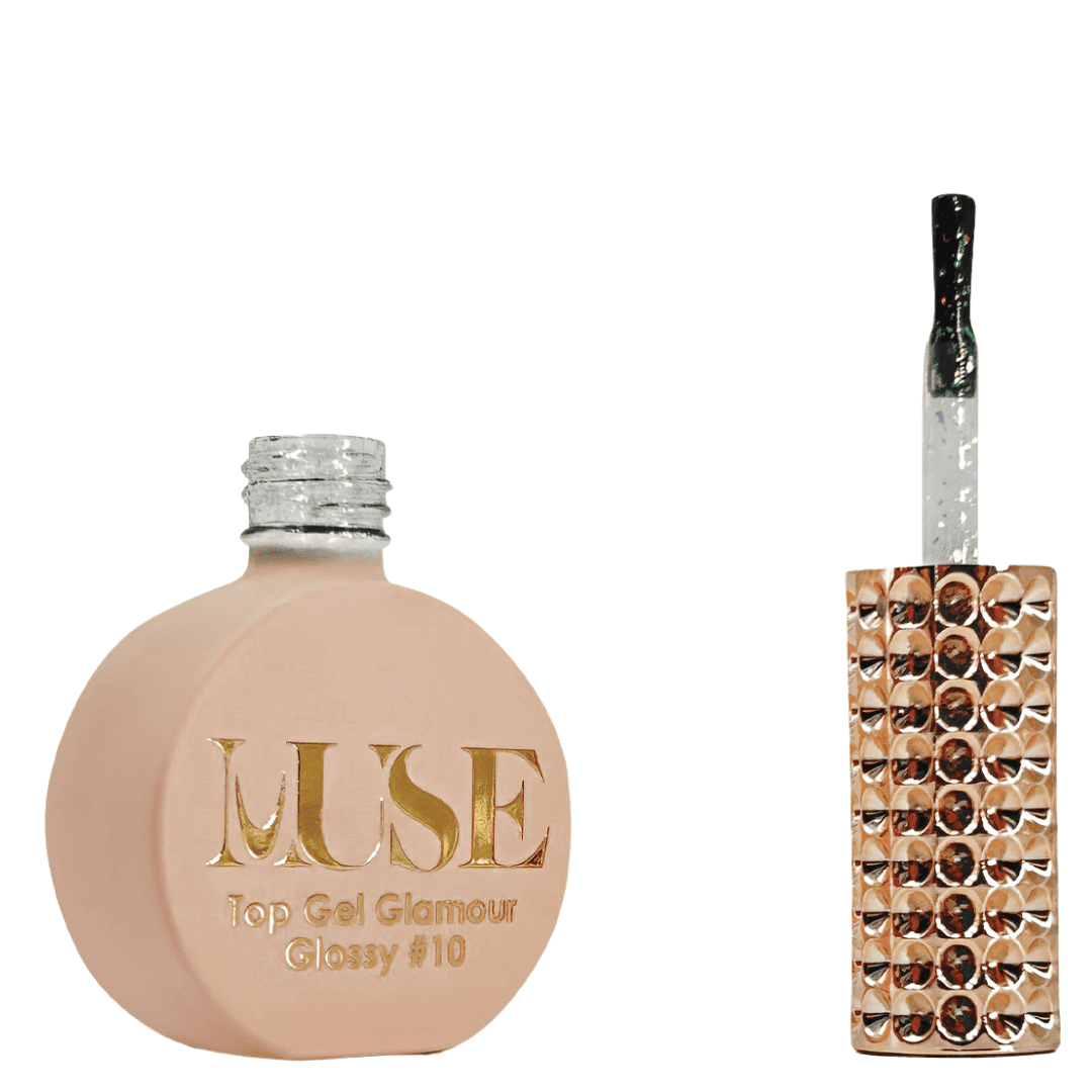 A bottle of MUSE Top Gel Glamour in Glossy #10, featuring a flat, round base finished in matte peach. The silver glitter screw cap tops the bottle, and the brush applicator has a clear handle filled with sparkling silver glitter. The bottle showcases the MUSE logo in gold lettering with the product name "Top Gel Glamour Glossy #10" just below it.