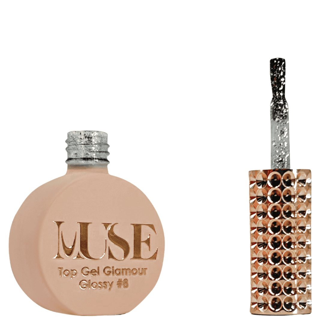 A bottle of MUSE Top Gel Glamour in Glossy #8, displayed in a flat, round container with a matte peach finish. The cap is a silver glitter screw top, and the brush applicator features a clear handle encrusted with silver sparkles. The label on the bottle is adorned with the MUSE logo in luxurious gold lettering with "Top Gel Glamour Glossy #8" inscribed below.
