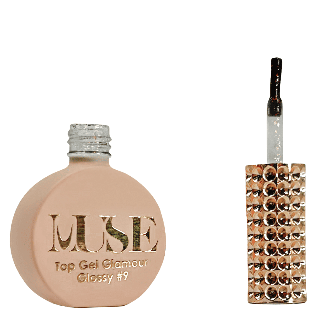 A bottle of MUSE Top Gel Glamour in Glossy #9, depicted with a flat, round base in a matte peach color. The cap is a silver glitter screw top, and the brush applicator has a clear handle filled with a glittery substance. The front of the bottle is embellished with the MUSE logo in gold lettering, with "Top Gel Glamour Glossy #9" indicated below.