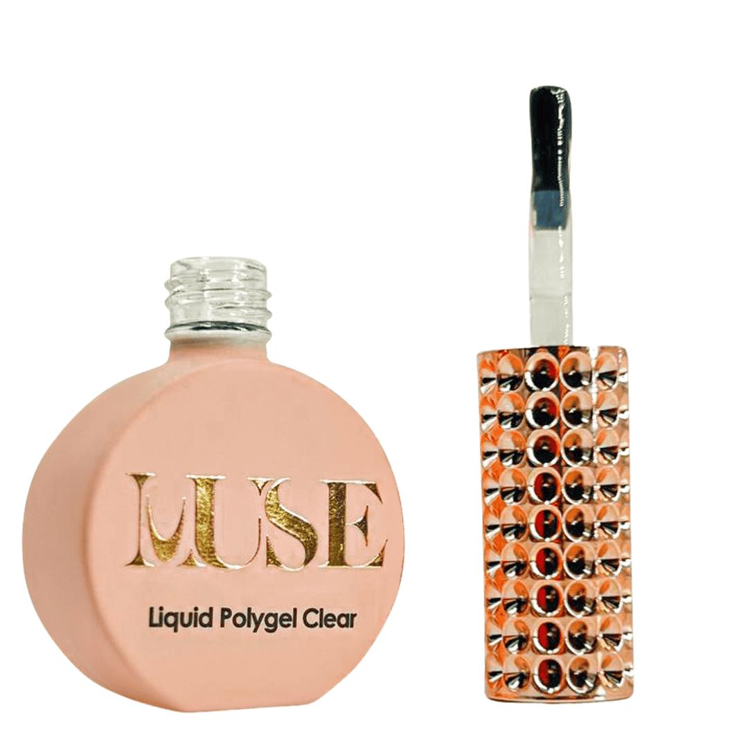 A round, flat bottle of "MUSE Liquid Polygel Clear" with a metallic gold logo on a matte peach background, next to a nail brush with a handle covered in a pattern of reflective orange gemstones.