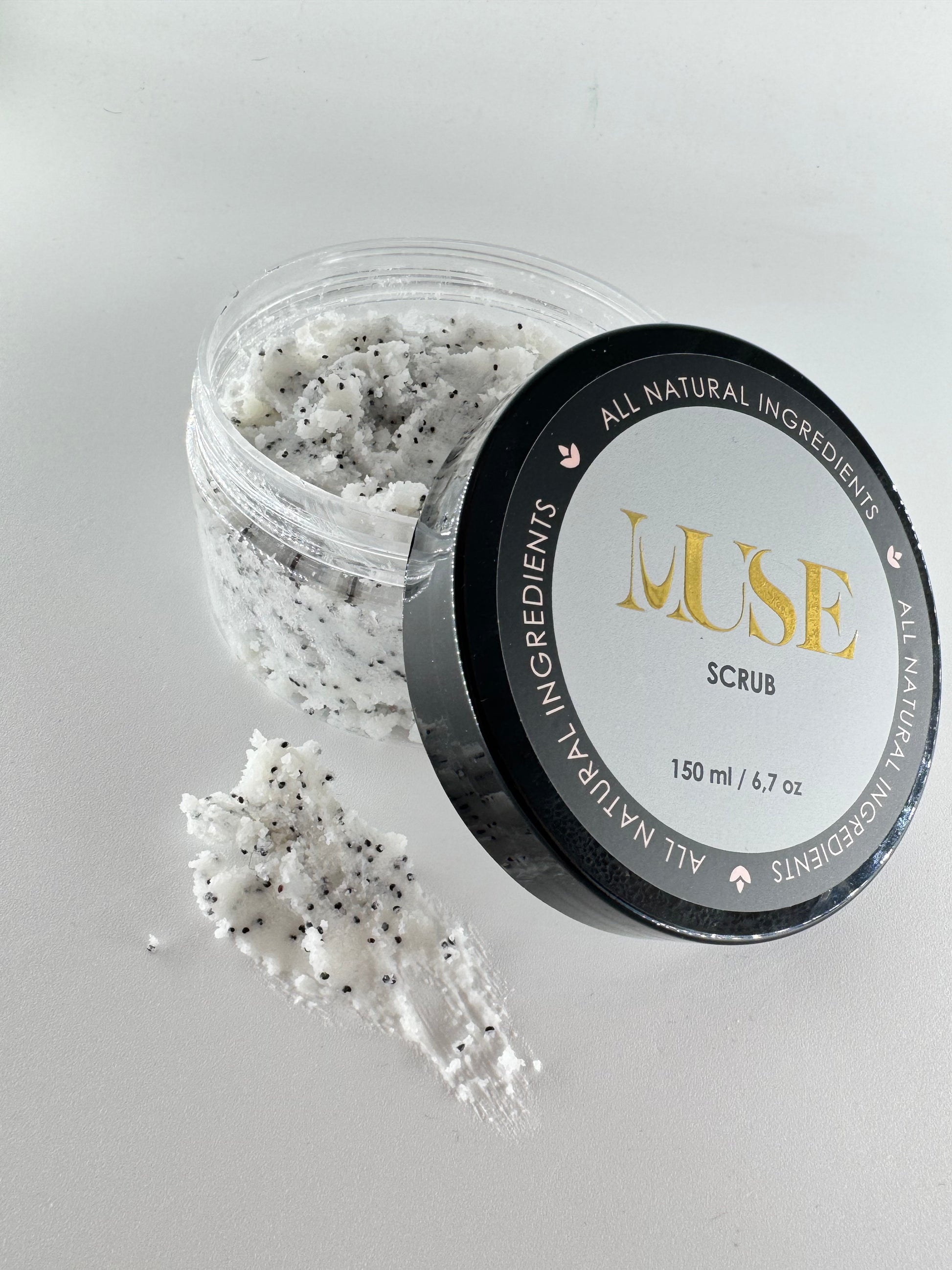 Detailed shot of Muse Hands and Feet Scrub's rich, creamy texture with visible sea salt granules, highlighting the all-natural ingredients used for effective exfoliation