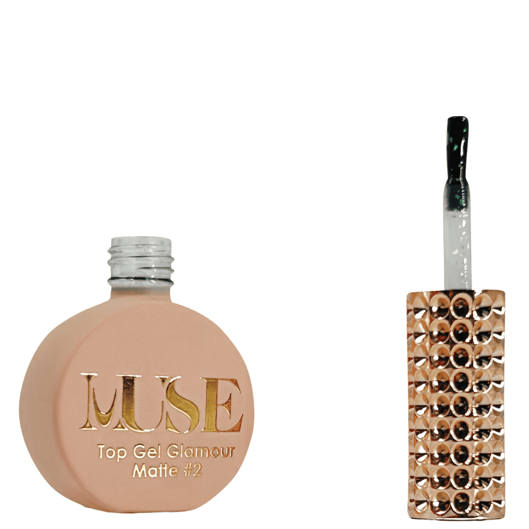 A bottle of MUSE Top Gel Glamour in Matte #2, presented with a flat, circular base finished in a matte peach shade. The cap is adorned with a silver glitter coating, and the brush applicator includes a clear handle embedded with sparkling glitter. The label on the bottle is inscribed with the MUSE logo in gold, alongside the text "Top Gel Glamour Matte #2".