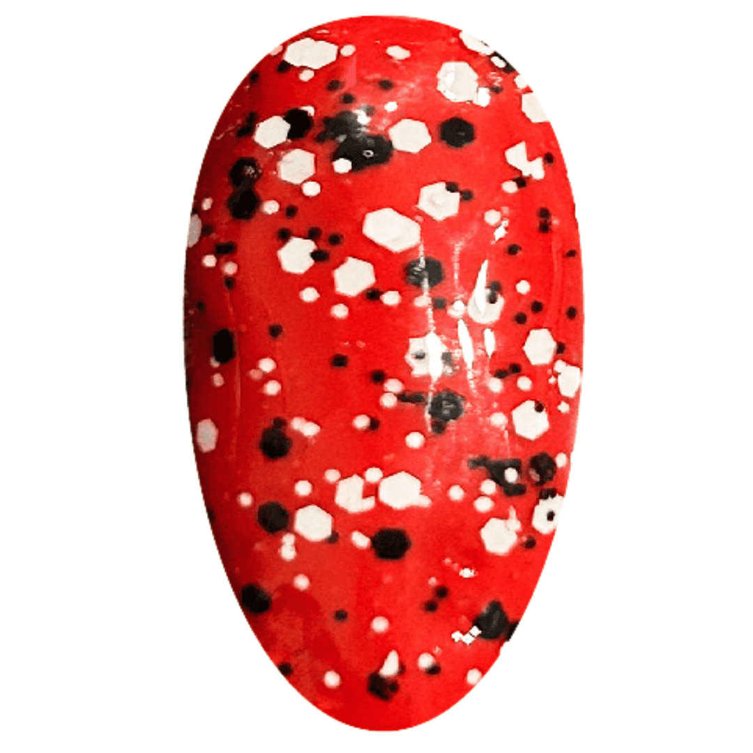 a swatch of vibrant red nail polish with a scattered pattern of black and white speckles, displayed on a nail-shaped template. This design is reminiscent of a contemporary take on a classic polka dot pattern, giving off a playful and eye-catching appearance.