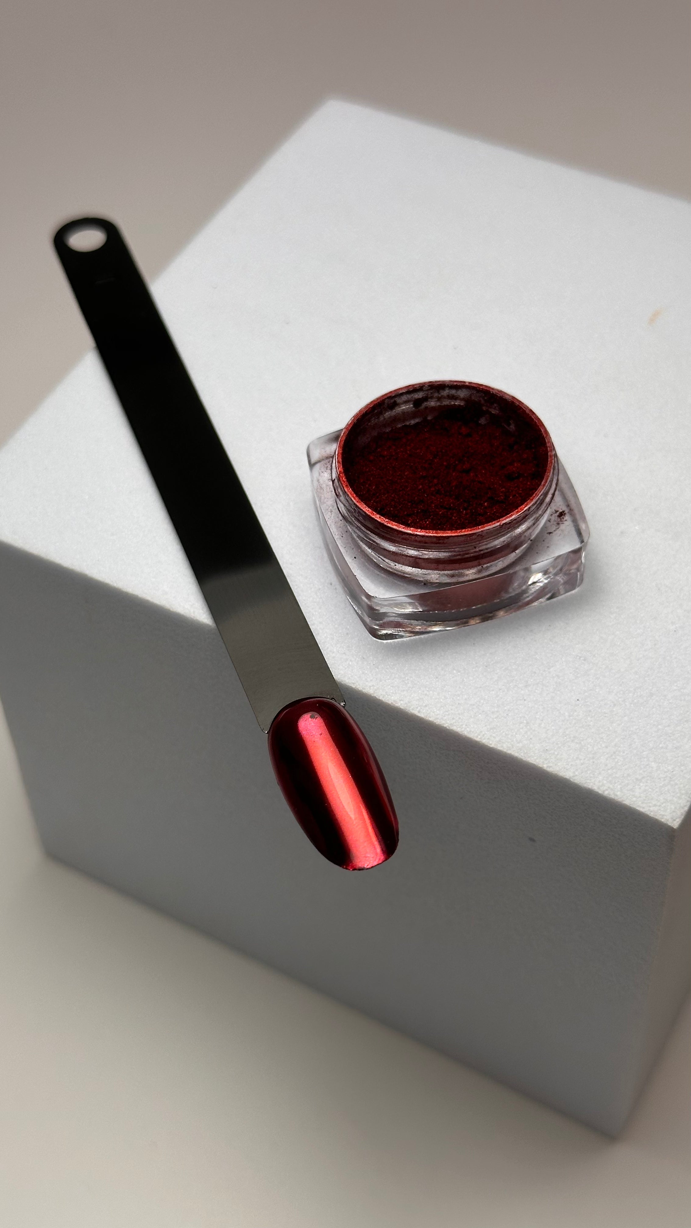 Muse Metallic Chrome Powder in red container with a small brush applicator, perfect for achieving a polished look.