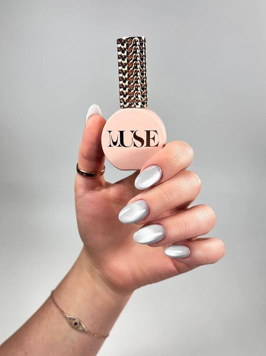 Cat Eye Silver Gel Polish is your go-to for creating dynamic, eye-catching nail designs with a professional finish. This luxurious metallic silver shade, infused with ultra-fine magnetic particles, allows nail artists to craft mesmerizing effects that shimmer and shift with every angle. From sleek and minimalist to bold and dramatic, the possibilities are endless with Muse’s Cat Eye Silver.