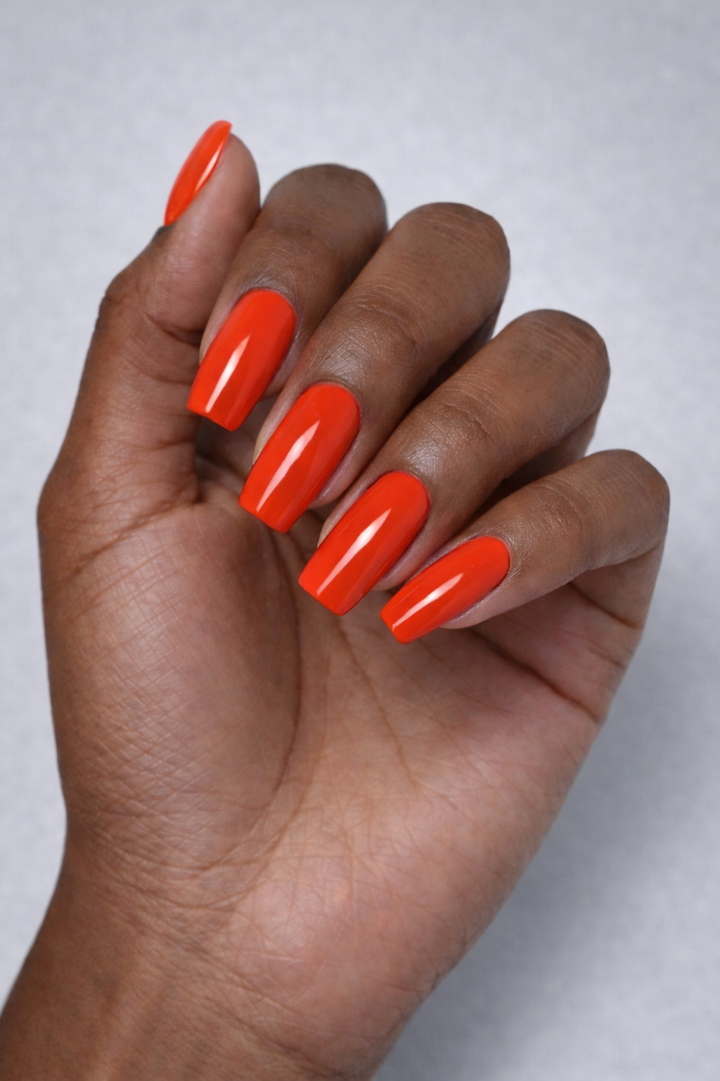 warm red orange gel polish manicure