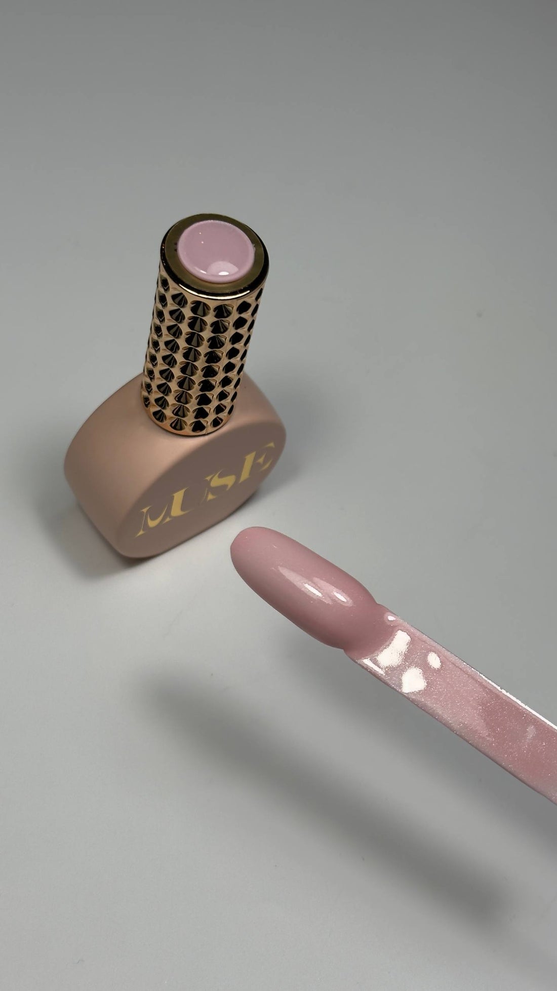 Soft neutral pink gel polish with luminous shimmer finish