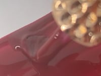 Swatch of Ruby Red Nail Base Gel showcasing its bold and vibrant ruby-red shade.